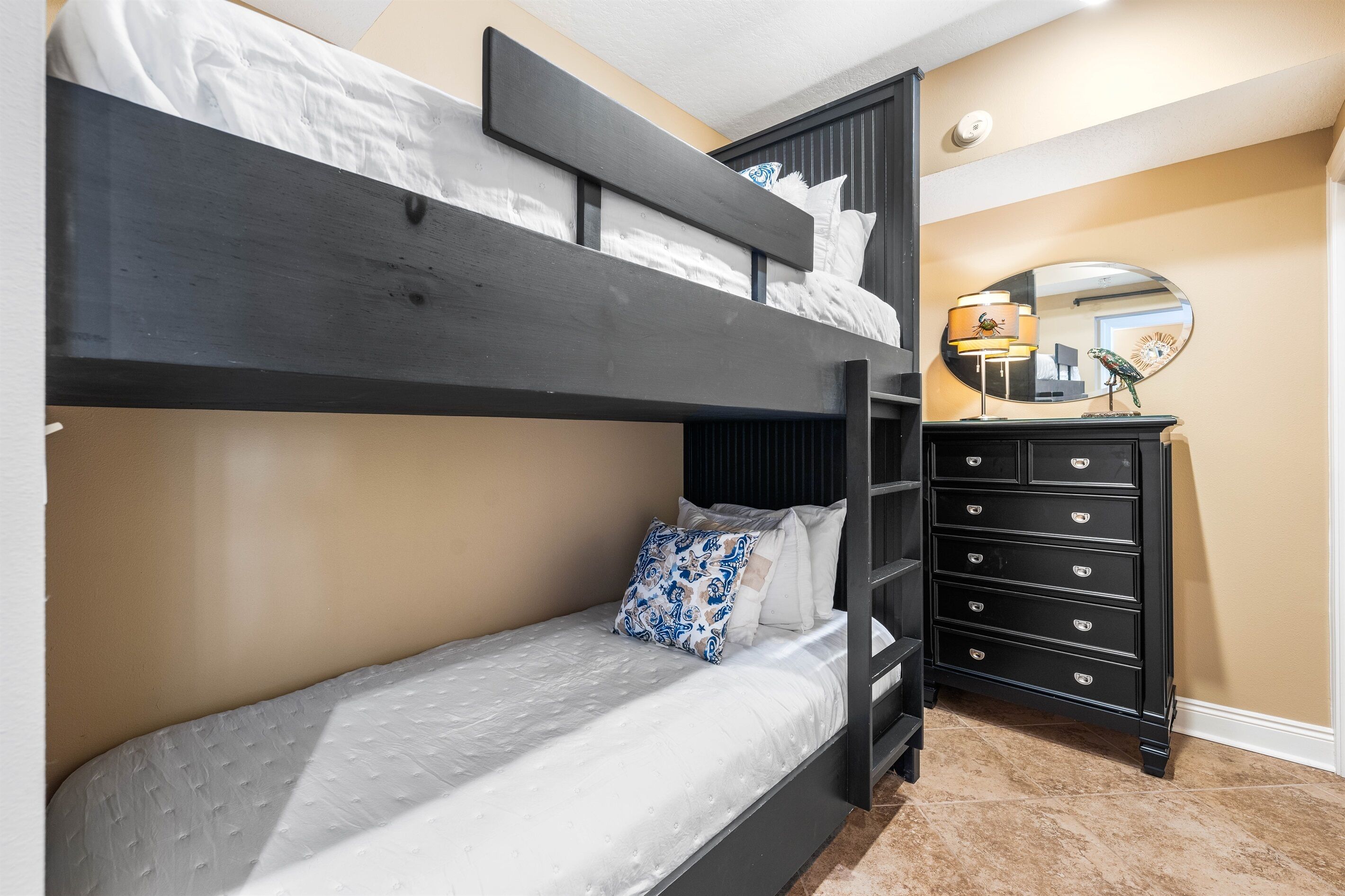 A bunk bed with a lower bed and a dresser with drawers.