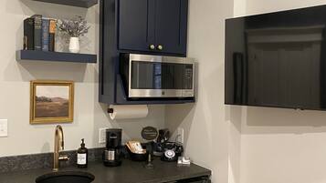 Fridge, microwave, coffee/tea maker, cookware/dishes/utensils