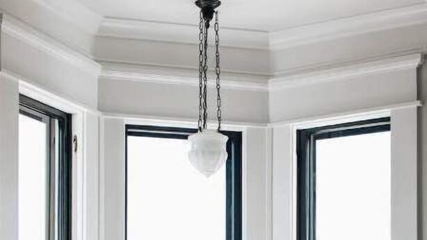 A room with large bay windows, a chandelier, and two chairs. - Ulysses Suites, Suite 302 (Galena)