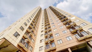 A high-rise building with multiple balconies and windows. - OYO Life 93310 Apartemen Tamansari Panoramic By Santuy 2 (Bandung)