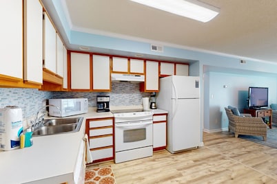 Wonderful beachfront condo with waterside pool, grilling area, open layout, & AC