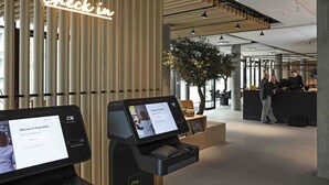 A modern hotel reception area with a 'Check-in' sign, a digital kiosk, and a reception desk. - Four Points Flex by Sheraton Hillerød (Hillerod)