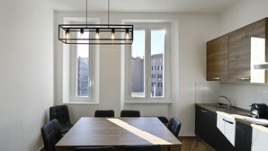 A modern kitchen with a wooden countertop, a built-in oven, and a sink. - St Peter DOC house (Roma)