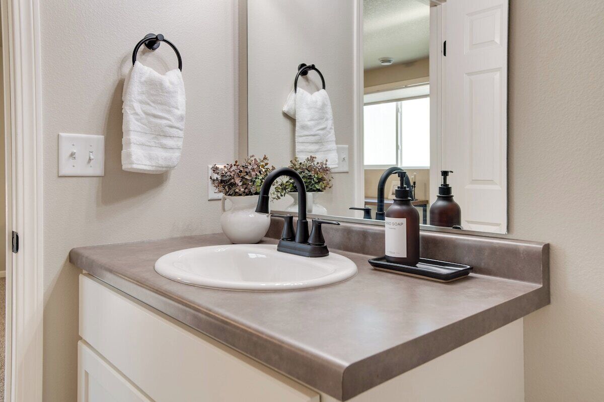 Downstairs bathroom featuring updated plumbing fixtures, modern lighting, and stylish hardware offering a fresh and functional space.