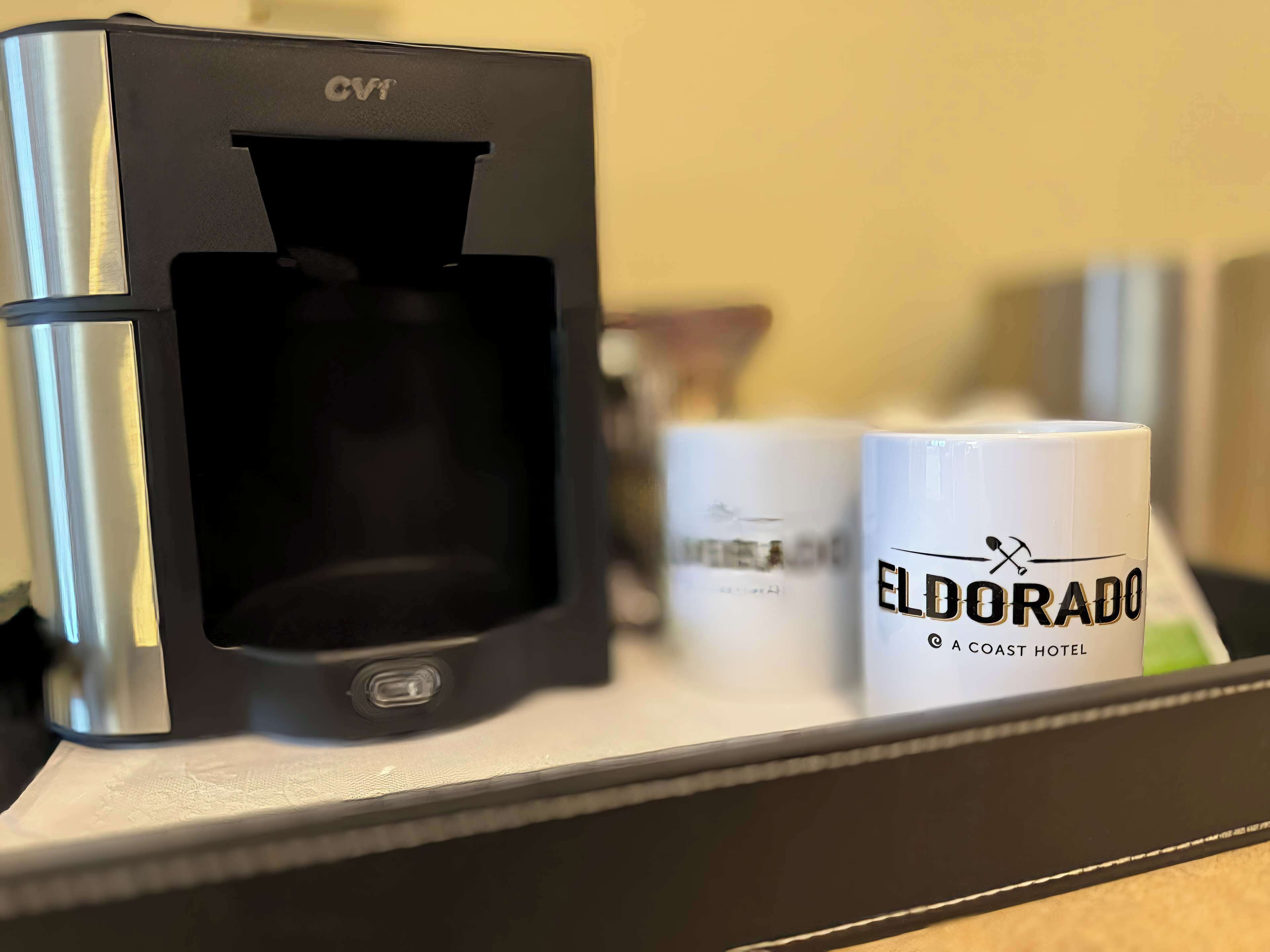 A coffee machine, two mugs, and a tray.