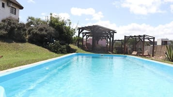 Outdoor pool, open 9:00 AM to 10:00 PM, pool loungers
