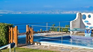 A pool area with a view of the sea and a cityscape in the background. - Villa with swimming pool & barbecue, sea view on Capri, Amalfi Coast 20 min away (Massa Lubrense)