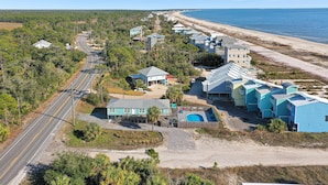 A coastal resort with multiple buildings, a road, and a beach. - Castaway (Port St. Joe)