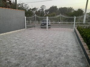 entrance to a serene residential property surrounded by lush greenery.