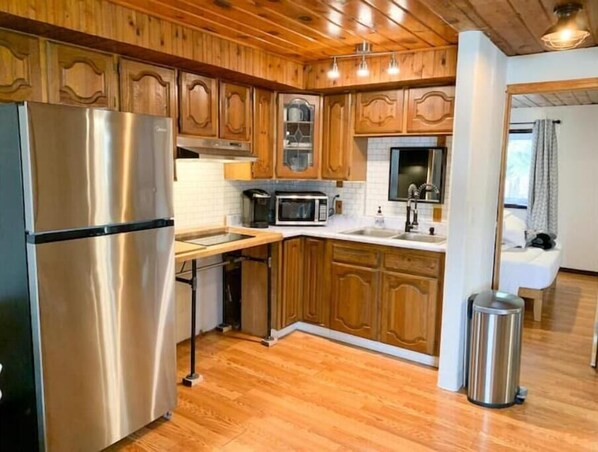 Køleskab, kaffe-/temaskine, køkkentøj/tallerkener/redskaber, Servietter