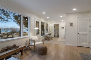Enjoy a room with a high ceiling, large windows, and a comfortable seating area.