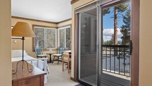 A room with a bed, a desk, a chair, a table, and a window with blinds. - Mammoth Getaway, Short walk to the Village and steps to Canyon Lodge shuttle. (Mammoth Lakes)
