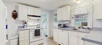 Inviting, two-story home with a large yard, sunroom, balcony, & washer/dryer
