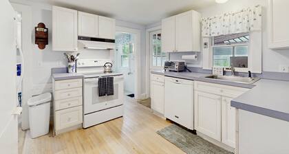 Inviting, two-story home with a large yard, sunroom, balcony, & washer/dryer