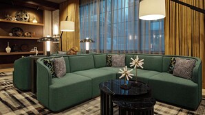A modern living room with a sectional sofa, two floor lamps, and a patterned rug. - Hotel Nickel Plate Fishers, Tapestry Collection By Hilton (Fishers)