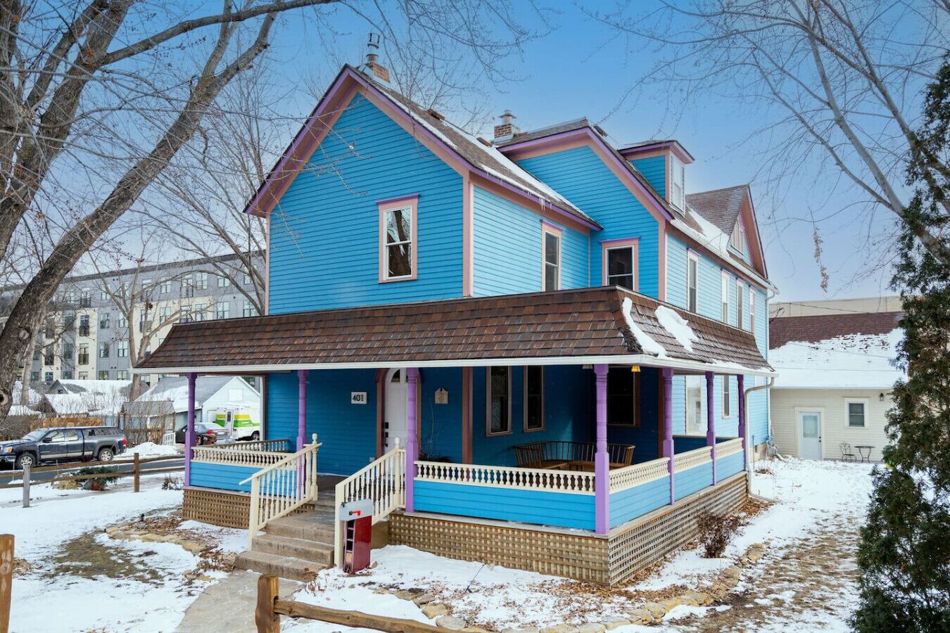 A two-story house with a porch, a visible number '401' on the front, and a snow-covered ground.