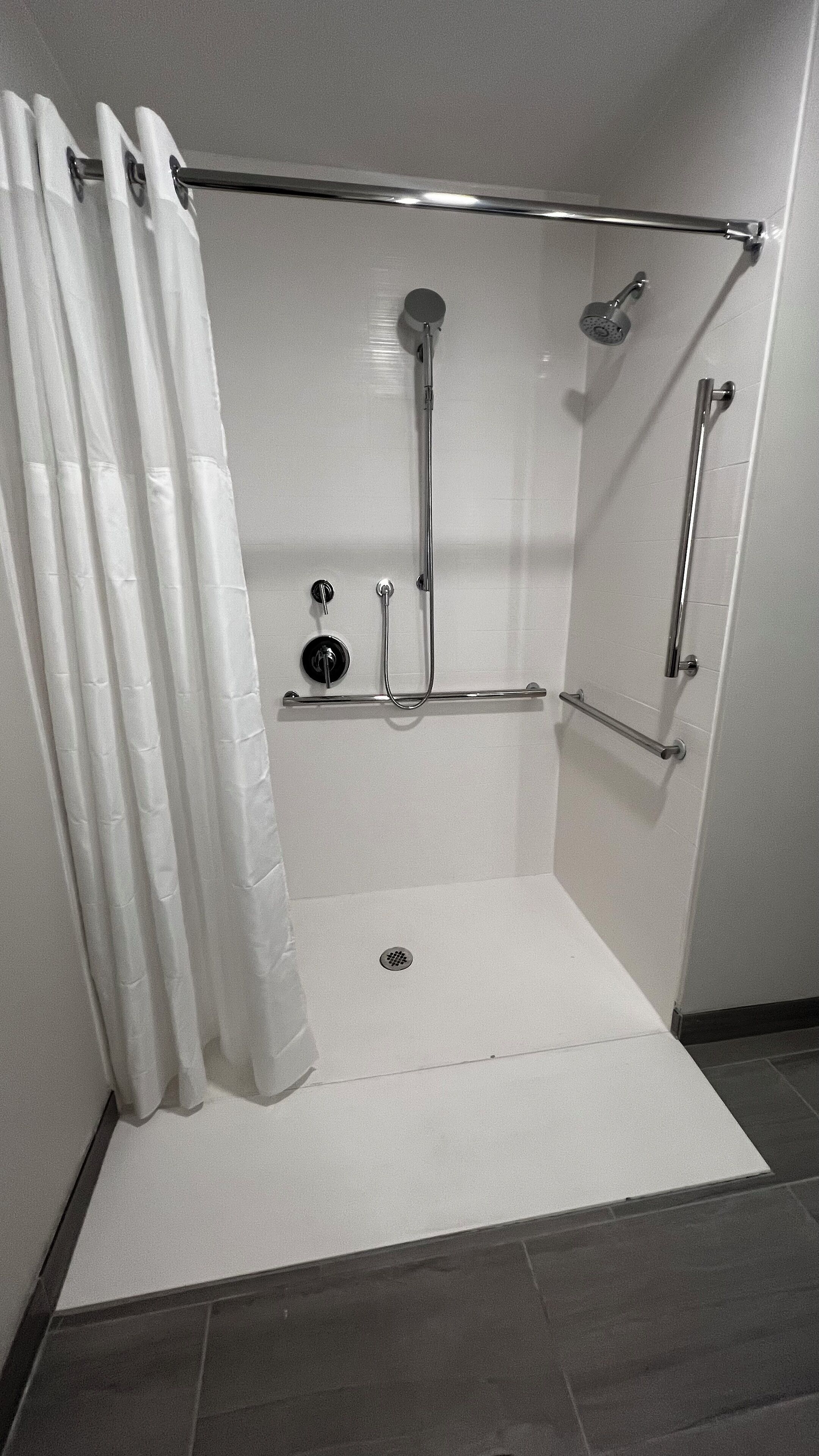 A walk-in shower with a glass door, a handheld showerhead, a handheld shower head, a handheld shower head, a handheld shower head, a handheld shower head, a handheld shower head, a handheld shower head, a handheld shower head, a handheld shower head, a handheld shower head, a handheld shower head, a handheld shower head, a handheld shower head, a handheld shower head, a handheld shower head, a handheld shower head, a handheld shower head, a handheld shower head, a handheld shower head, a handheld shower head, a handheld shower head, a handheld shower head, a handheld shower head, a handheld shower head, a handheld shower head, a handheld shower head, a handheld shower head, a handheld shower head, a handheld shower head, a handheld shower head, a handheld shower head, a handheld shower head, a handheld shower head, a handheld shower head, a handheld shower head, a handheld shower head, a handheld shower head, a handheld shower