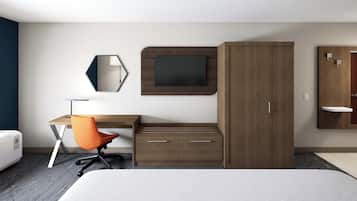 Une chambre d’hôtel comprenant un lit, un bureau avec une chaise, une armoire, un miroir et un téléviseur.