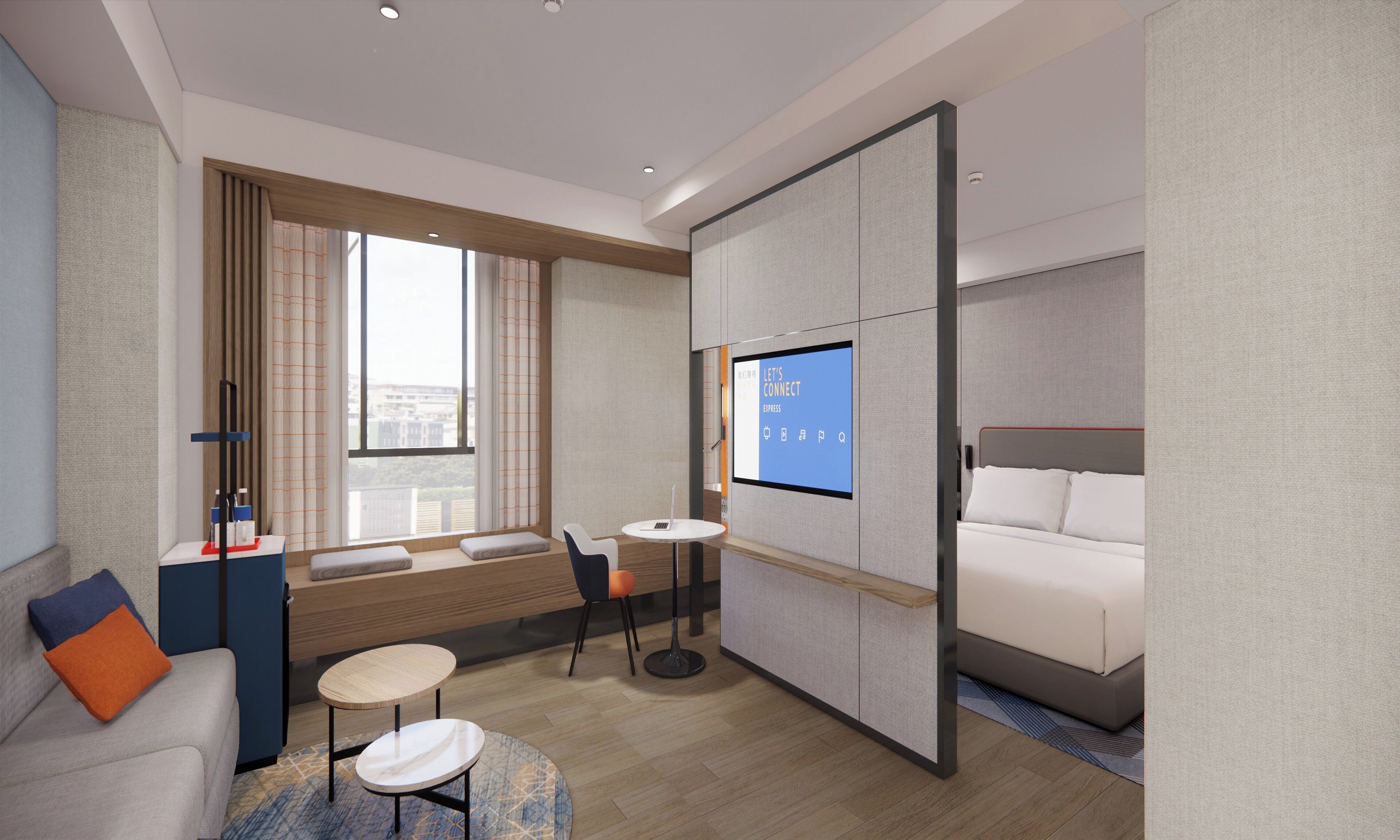 Una habitación de hotel moderna con una cama, una zona de estar con mesa y sillas, una pantalla de televisión y una ventana con cortinas.
