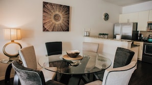 A modern kitchen with white cabinets, a stainless steel refrigerator, and a microwave. - Beautiful Townhouse Near the Parks, pool, gym,wifi and more! (Kissimmee)