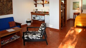 A compact living space with a kitchenette, a dining area, and a bedroom. - Stay, relax and explore in Sunrise, our tropical oasis by the Caribbean Sea. (Punta Gorda)