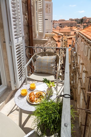 Enjoy breakfast on the balcony with a view of the city's historic skyline.