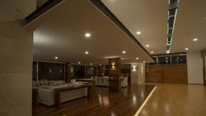 A spacious, modern interior with a wooden floor, a sofa, and a dining area. - Casa del Valle, cozy and with a beautiful view.  (Tepoztlán)