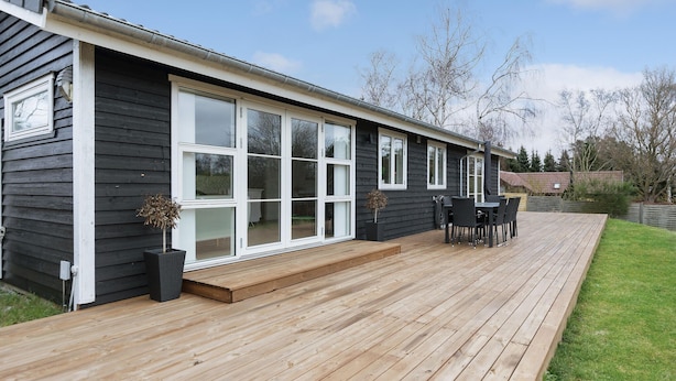 A modern house with a deck, large windows, and a patio area. - Gorgeous home in Melby with WiFi (Melby)