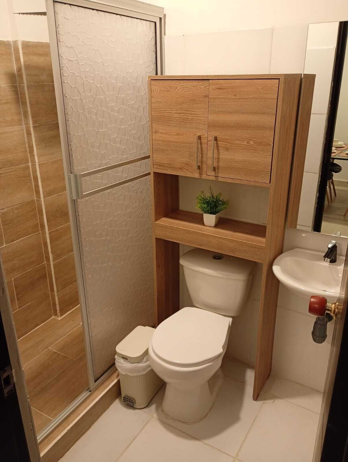 A bathroom with a shower, toilet, and sink.