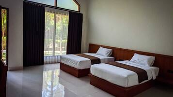 A hotel room with two beds, a large window with curtains, and a tiled floor.