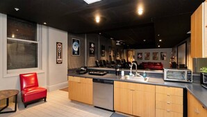 A modern kitchen with a central island, built-in dishwasher, and a microwave. - 2 units in 1! Silver Screen Getaway - Downtown Dsm (Des Moines)