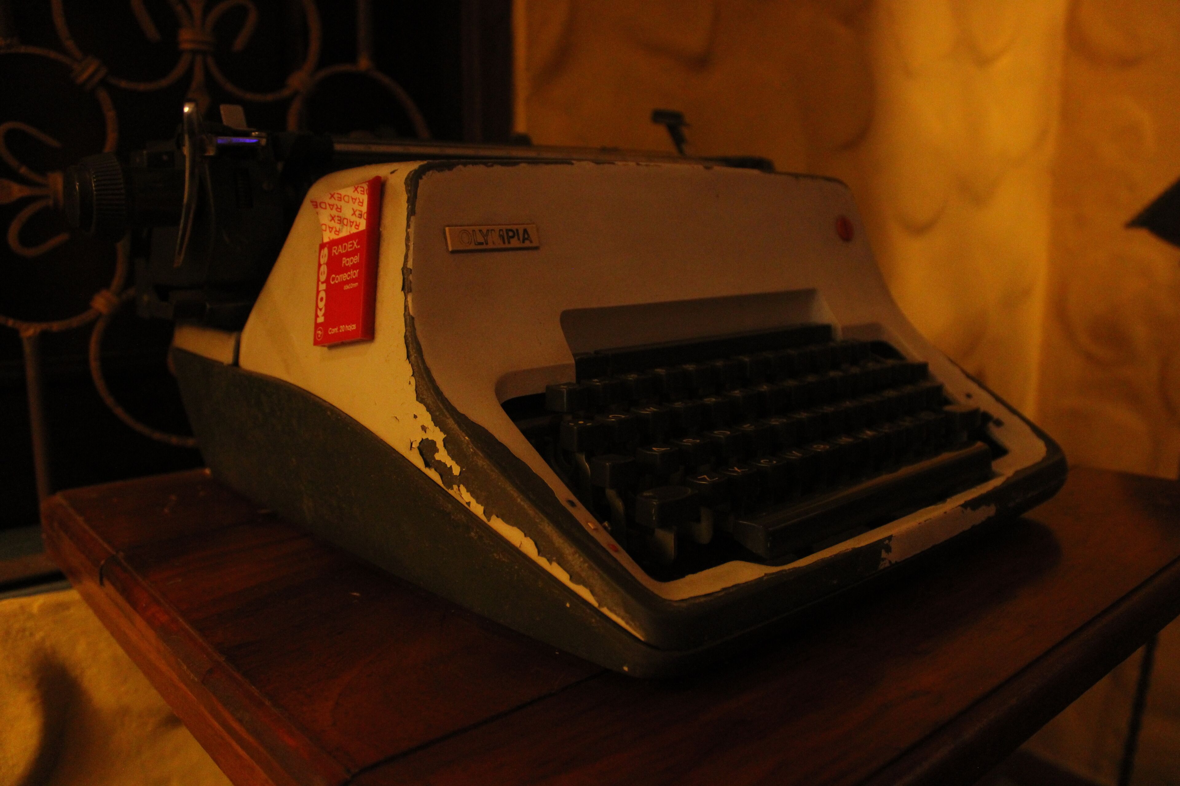 A vintage typewriter on a wooden table.