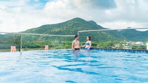 A swimming pool with a mountain backdrop, clear skies, and no visible people or decorations. - Con Son Blue Sea (Ho Chi Minh City)
