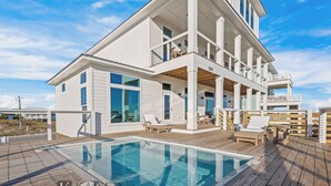 A modern two-story house with a large deck and a swimming pool. - Lavish Beach Sanctuary with Private Pool and Boardwalk | Sugar Shores by Kaiser Vacation Rentals (Gulf Shores)