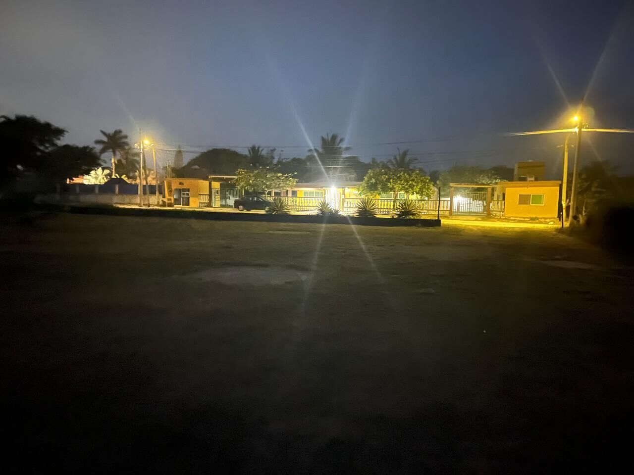 A parking lot with a building in the background.