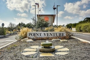 A sign reading "POINT VENTURE" with a fountain and decorative stones in front.