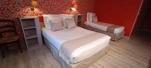 A bedroom with a bed, bedside tables, a chair, and a wardrobe. - HÔTEL DU SAUMON (Verneuil d'Avre et d'Iton)