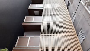 A modern building with multiple balconies and a sloped roof. - HOTEL FURIN (Fukuoka)