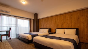 A hotel room with two beds, a wooden accent wall, a desk, and a chair. - HOTEL FURIN (Fukuoka)