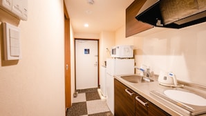 A compact kitchen with a microwave, refrigerator, and sink. - Hotel the Point KiyomizuGojo (Kyoto)