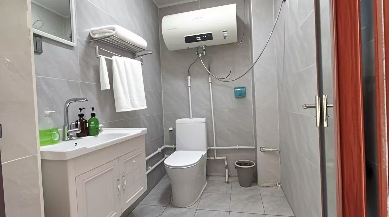 A modern bathroom with a toilet, sink, and shower.