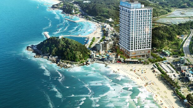 A coastal hotel with a modern design, beachfront access, and a view of the ocean.