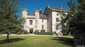 A large, historic building with multiple towers and a central entrance. - Chateau de Maillat (Maillat)