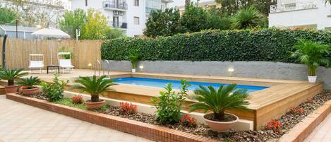Seasonal outdoor pool, pool umbrellas, pool loungers