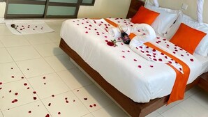 A hotel room with a bed, a canopy, and a sliding door.