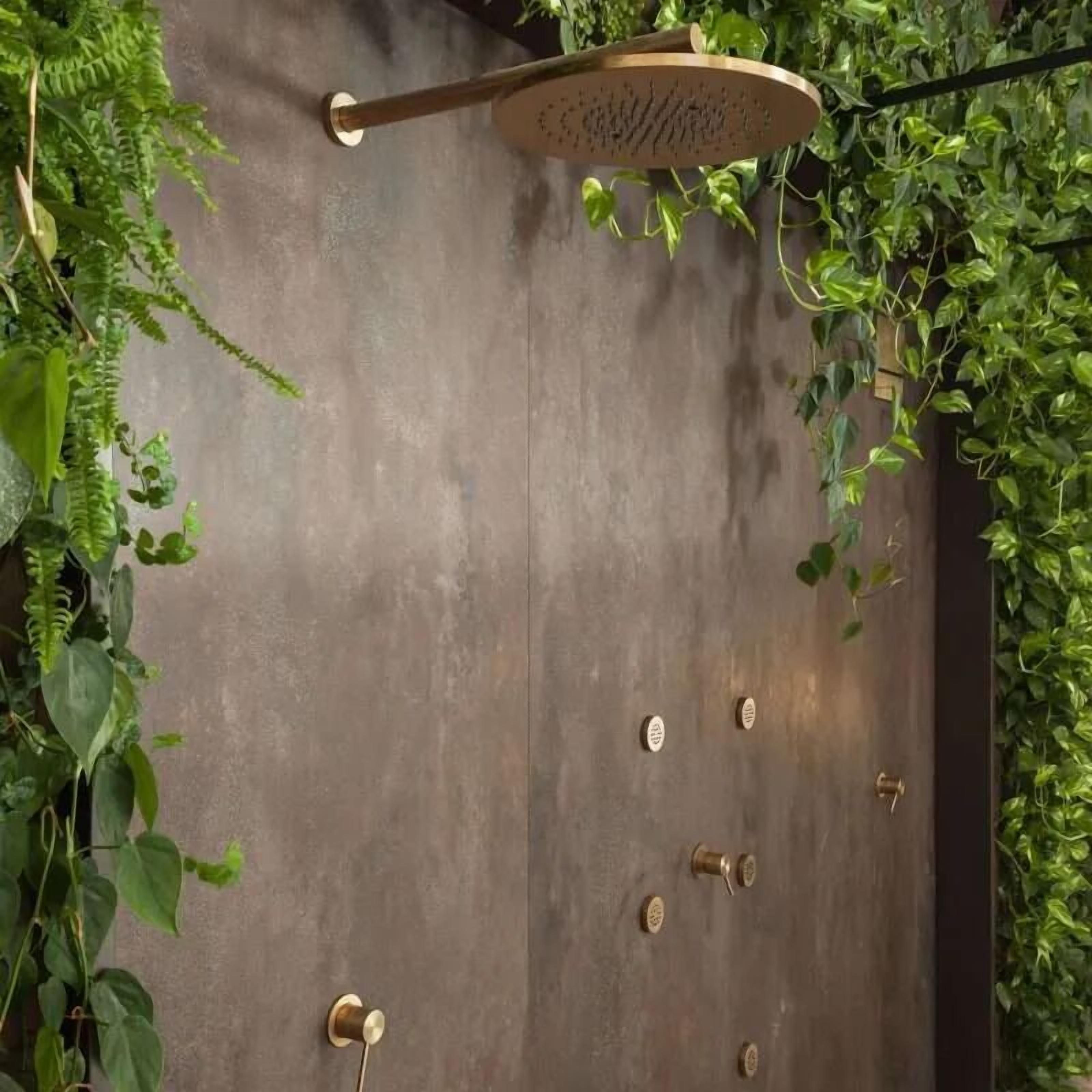 A shower area with a wooden handle and brass fixtures.
