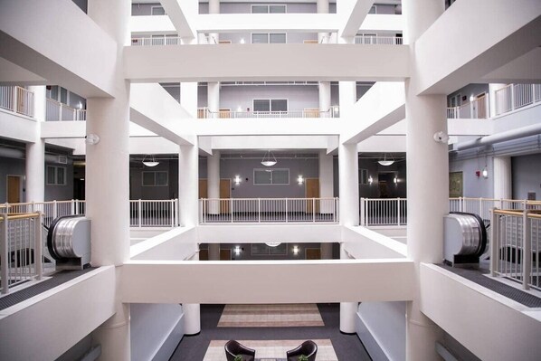Experience the airy, multi-level atrium with a mezzanine level above, offering a sense of openness.