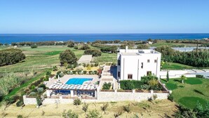 A modern two-story house with a swimming pool, surrounded by green fields and a view of the sea. - Karyo Villa,- 4bd, 3min On Foot From The Beach! (Pirgos)