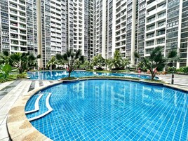 A swimming pool surrounded by high-rise residential buildings.