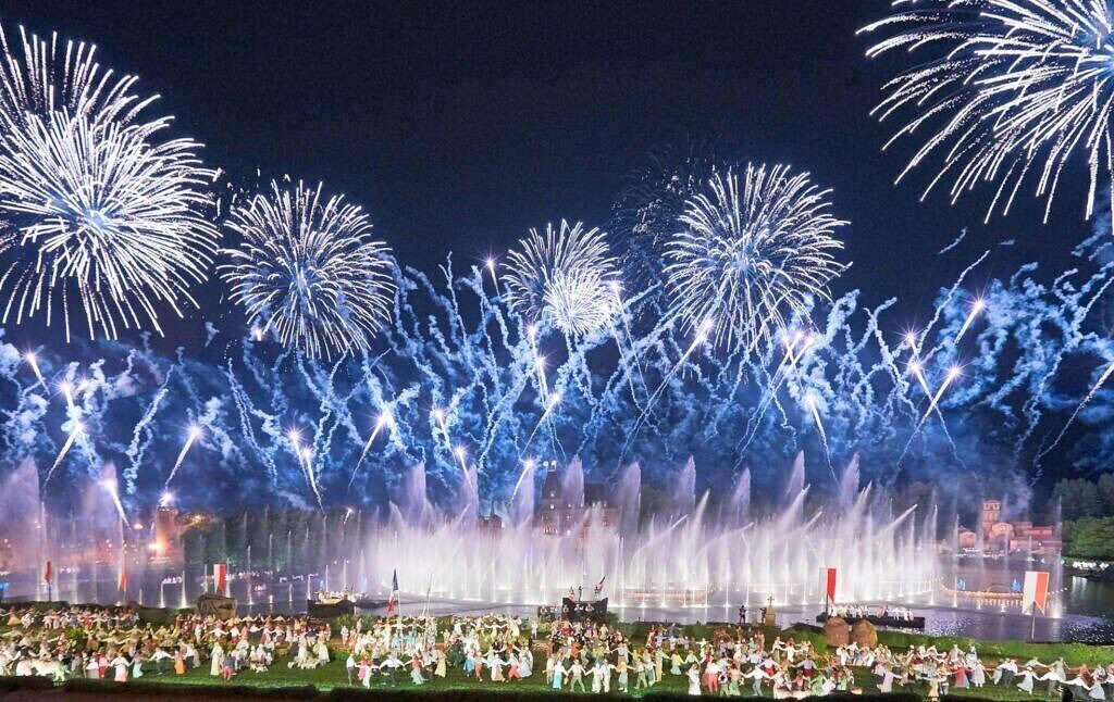 A nighttime outdoor event with fireworks and fountains.